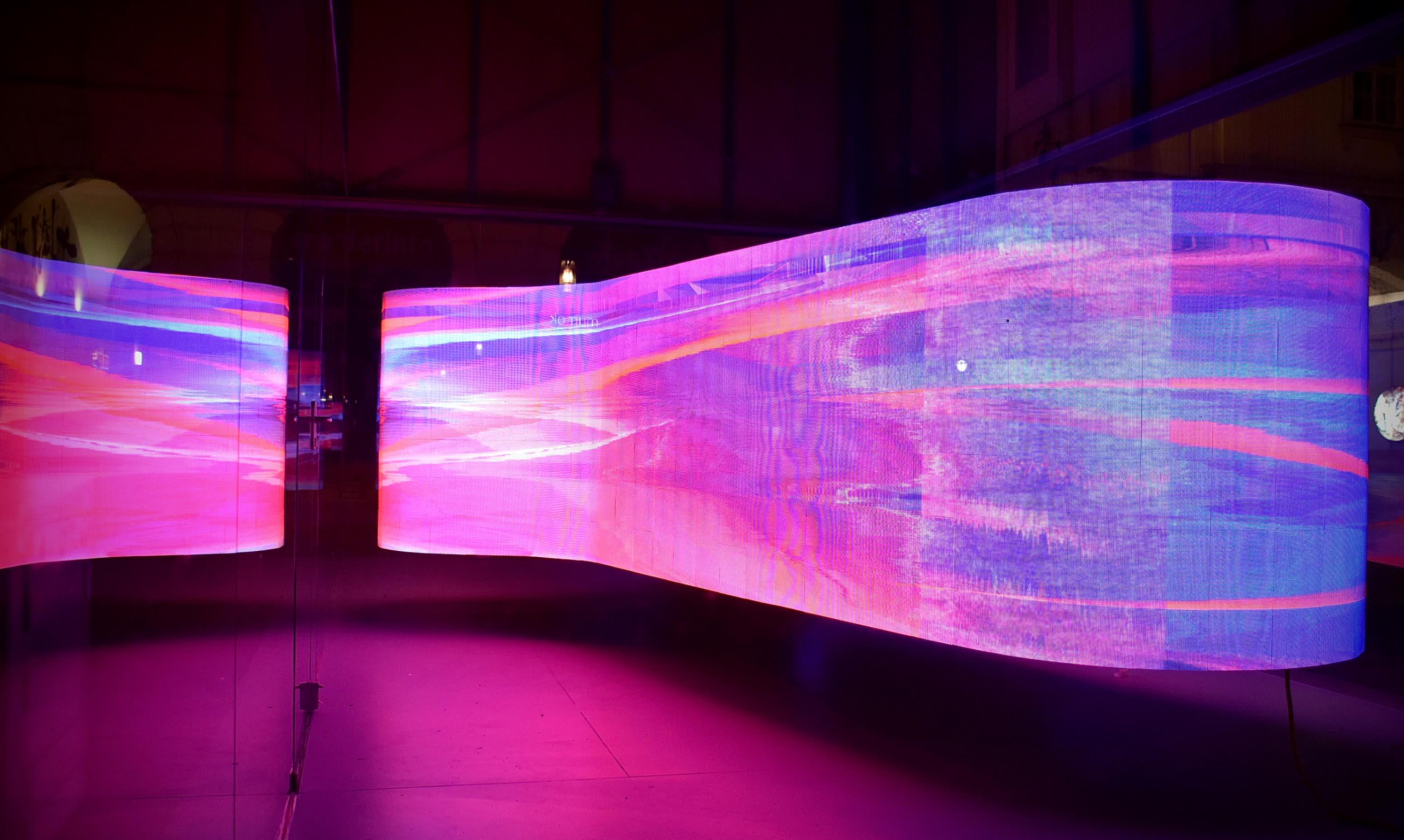 A curved LED video wall inside a showroom